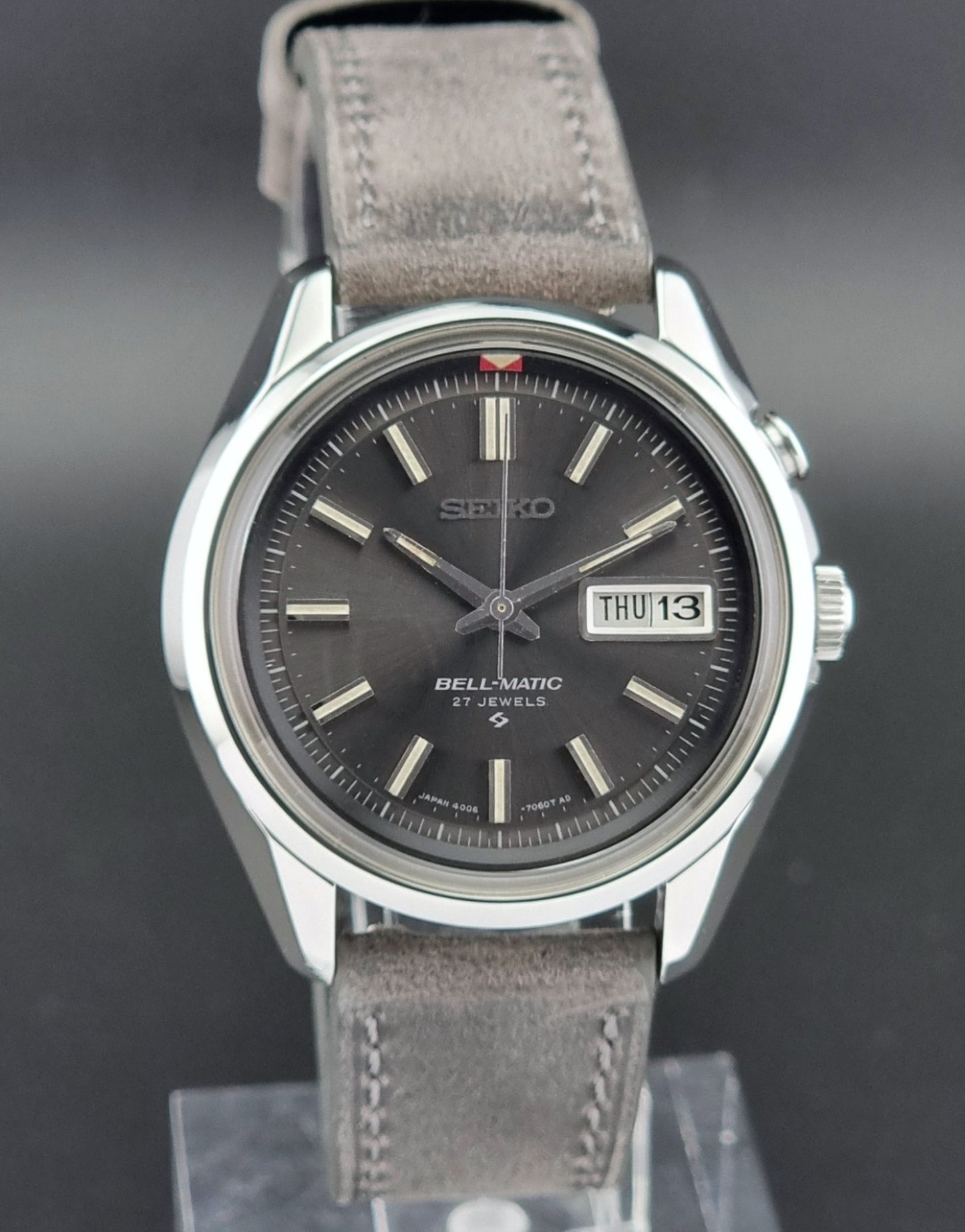 Seiko Bell-Matic watch with gray leather strap on a dark surface