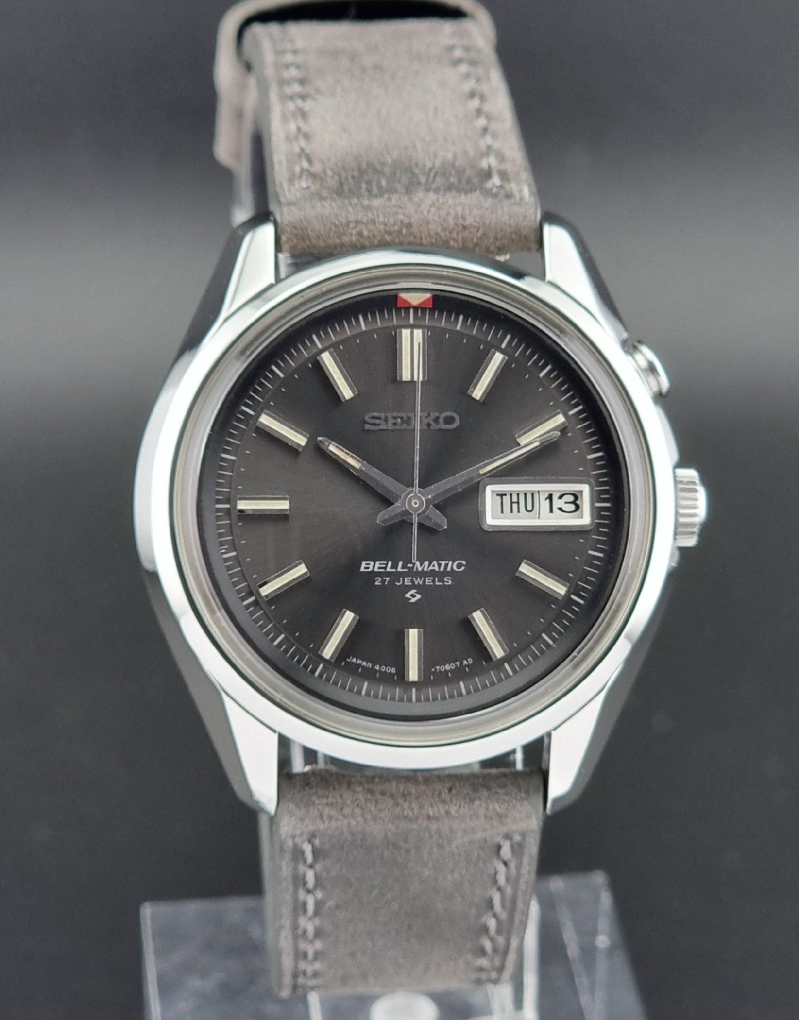 Seiko Bell-Matic watch with gray leather strap on a dark surface