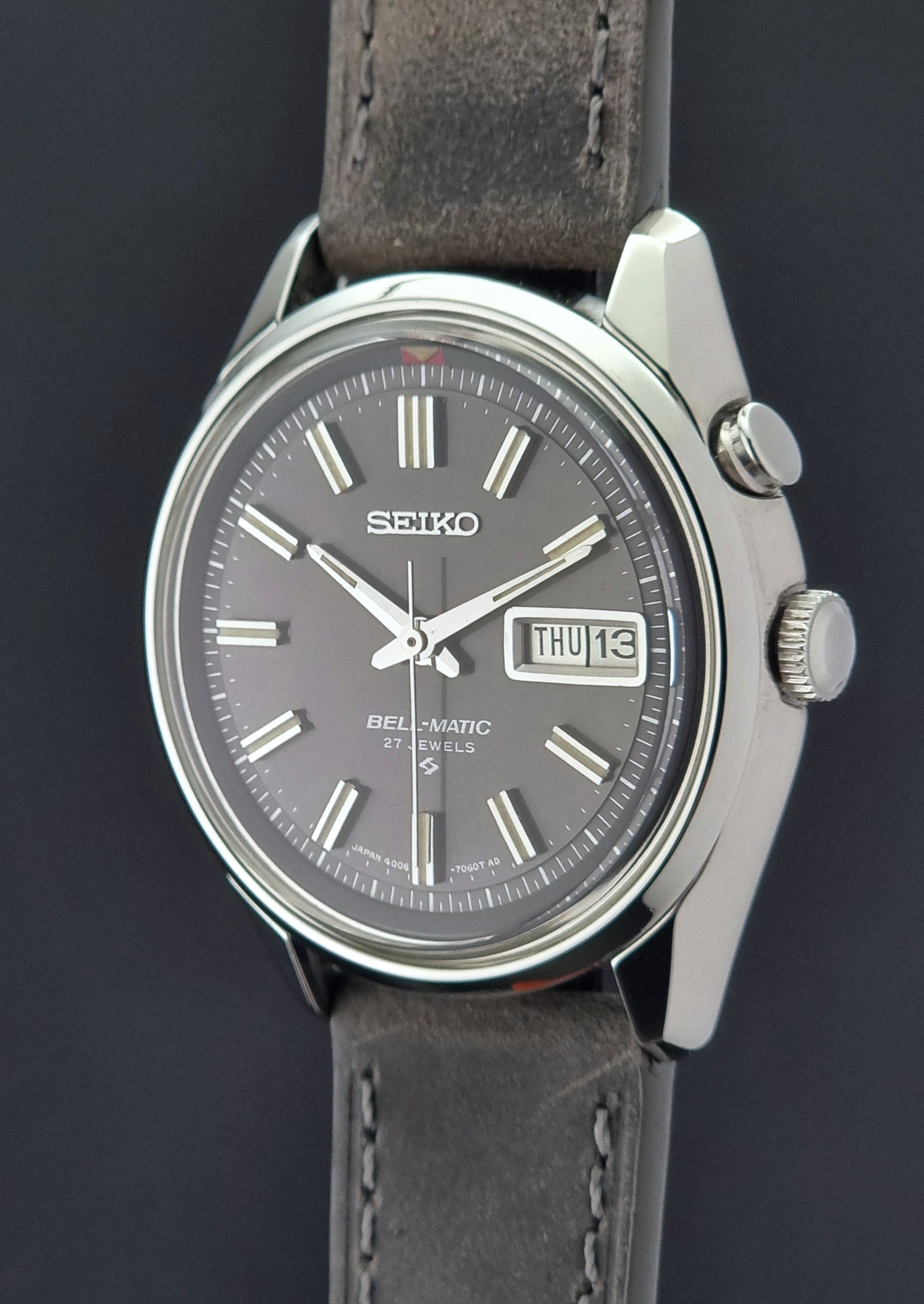 Seiko Bell-Matic watch with gray leather strap on a dark surface