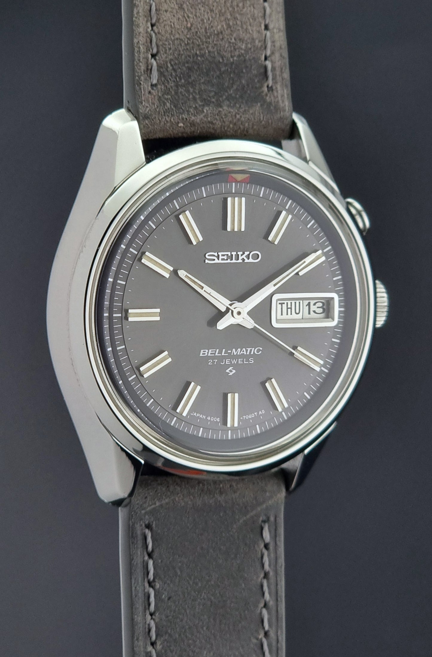 Seiko Bell-Matic watch with gray leather strap on a dark surface