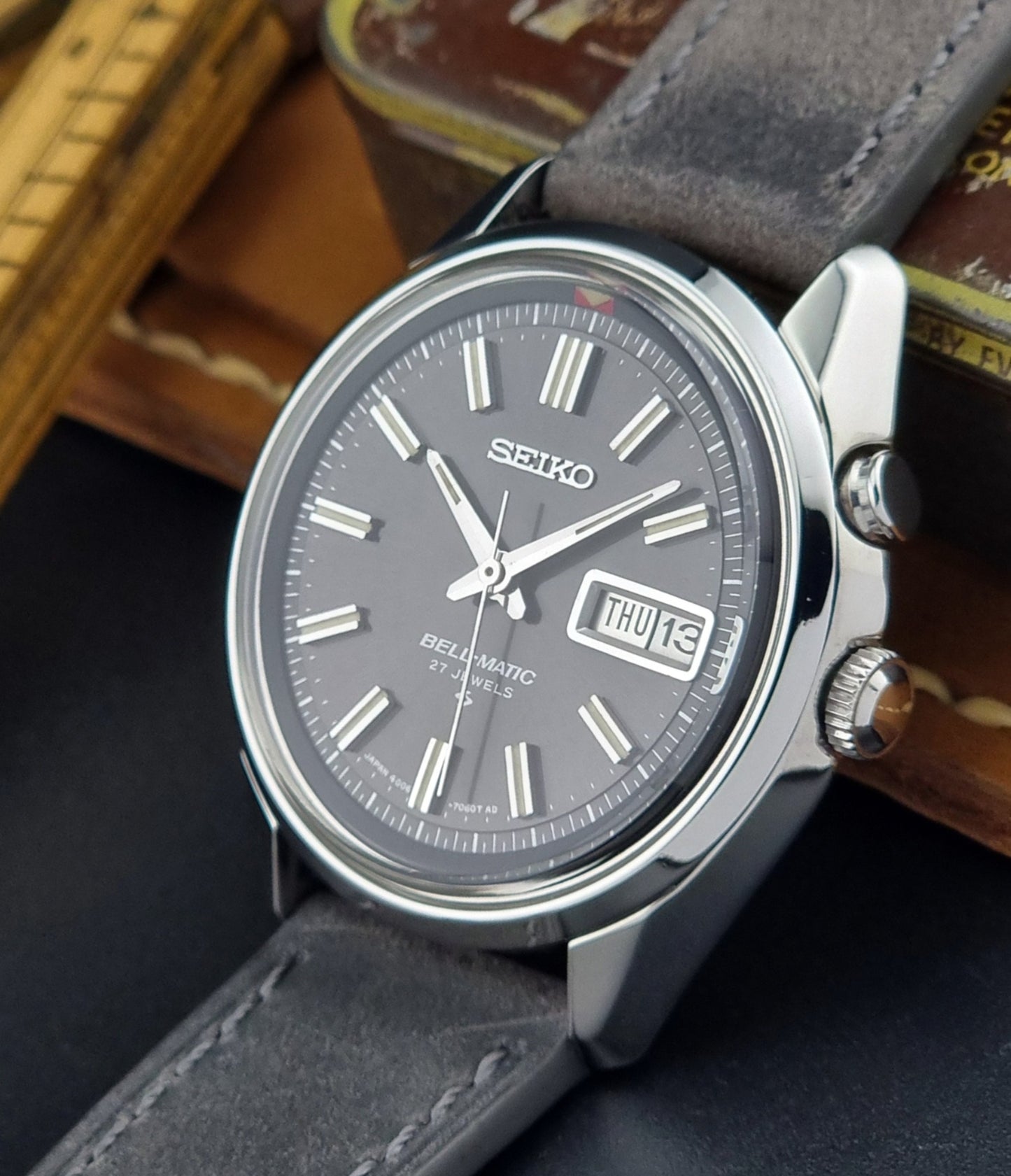 Seiko Bell-Matic watch with gray leather strap on a dark surface