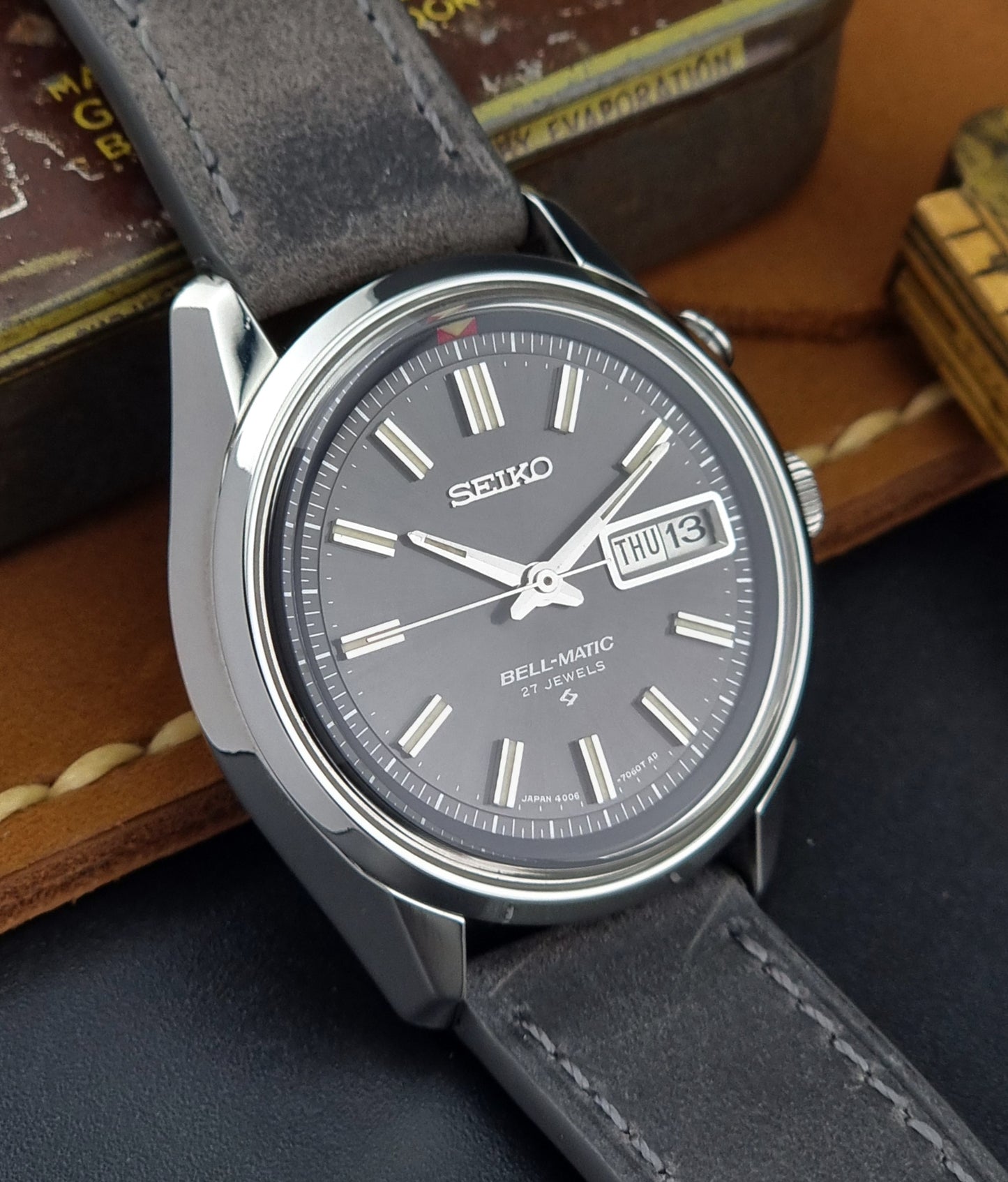 Seiko Bell-Matic watch with gray leather strap on a dark surface