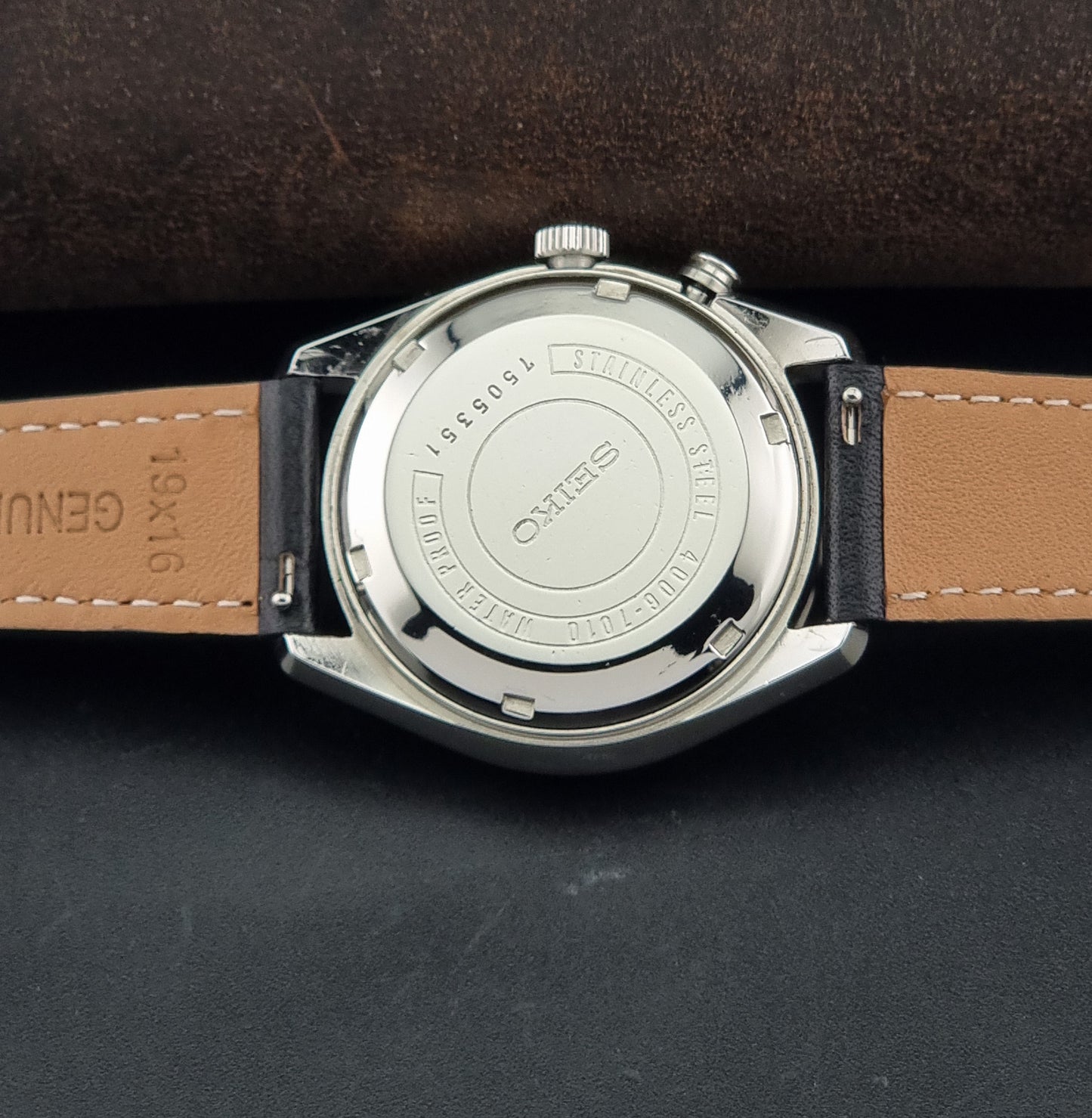 A Vintage Seiko Wristwatch Bell Matic Alarm 4006-7010 close-up of the back, resting on a dark textured surface.