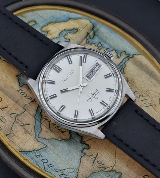 Vintage Seiko Lord Matic watch with black strap on an old map background