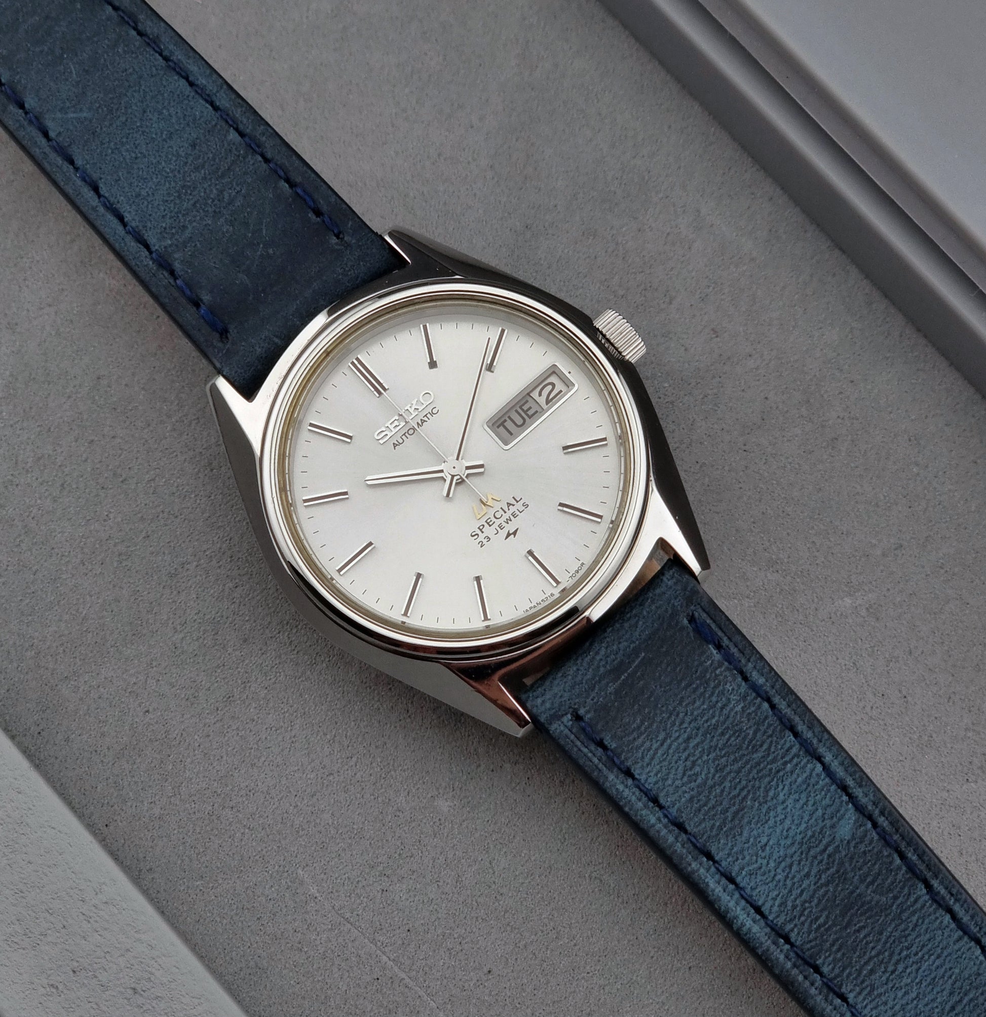 Seiko Wristwatch LordMatic Special 5216-7080 Vintage 1974 watch with blue strap on a gray surface