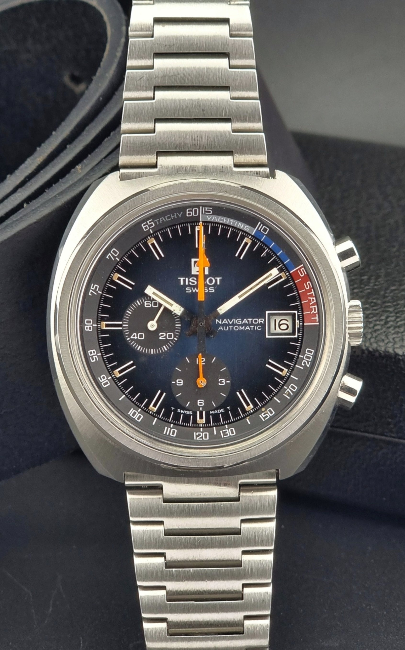 Vintage Tissot wristwatch with a dark face on a black background