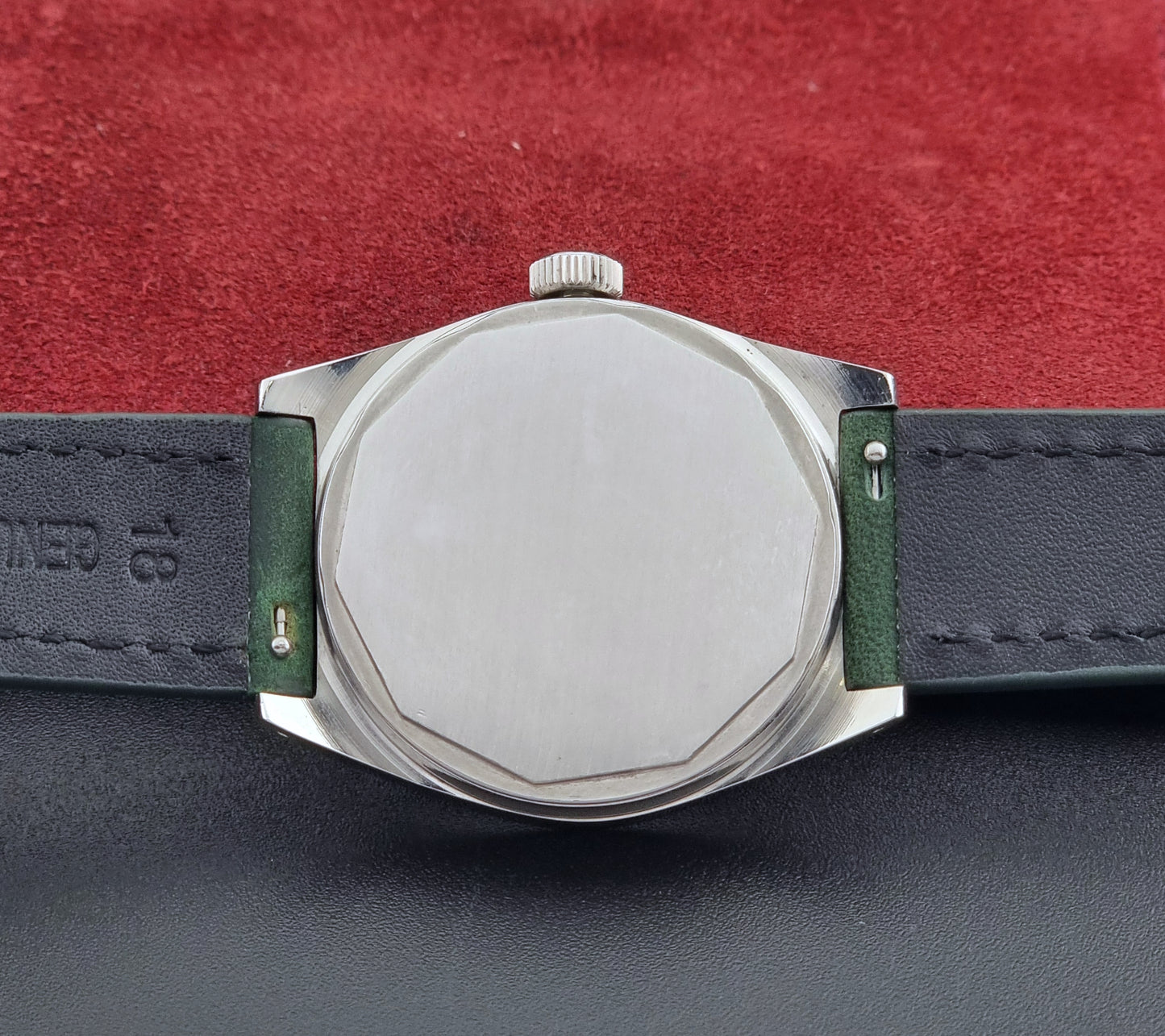 Vintage Tissot 41620 PR 516 wristwatch with green strap and silver case on a gray background case back view