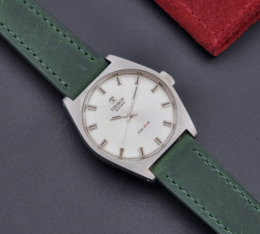 Vintage Tissot 41620 PR 516 wristwatch with green strap and silver case on a gray background front