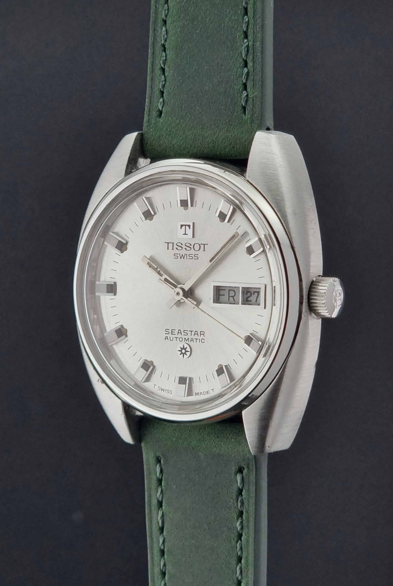 Tissot Seastar 46660 watch with green strap on a dark background