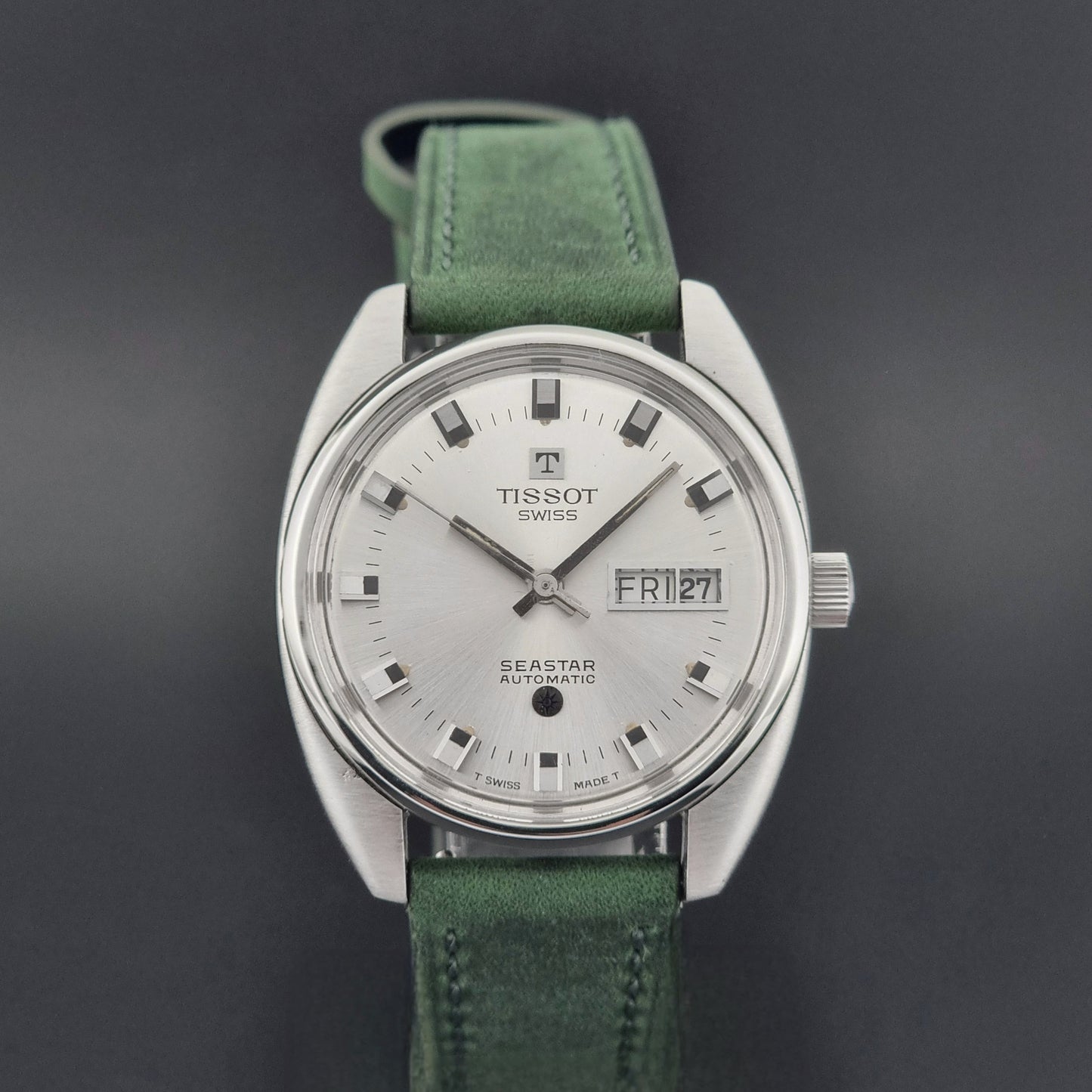 Tissot Seastar 46660 watch with green strap on a dark background