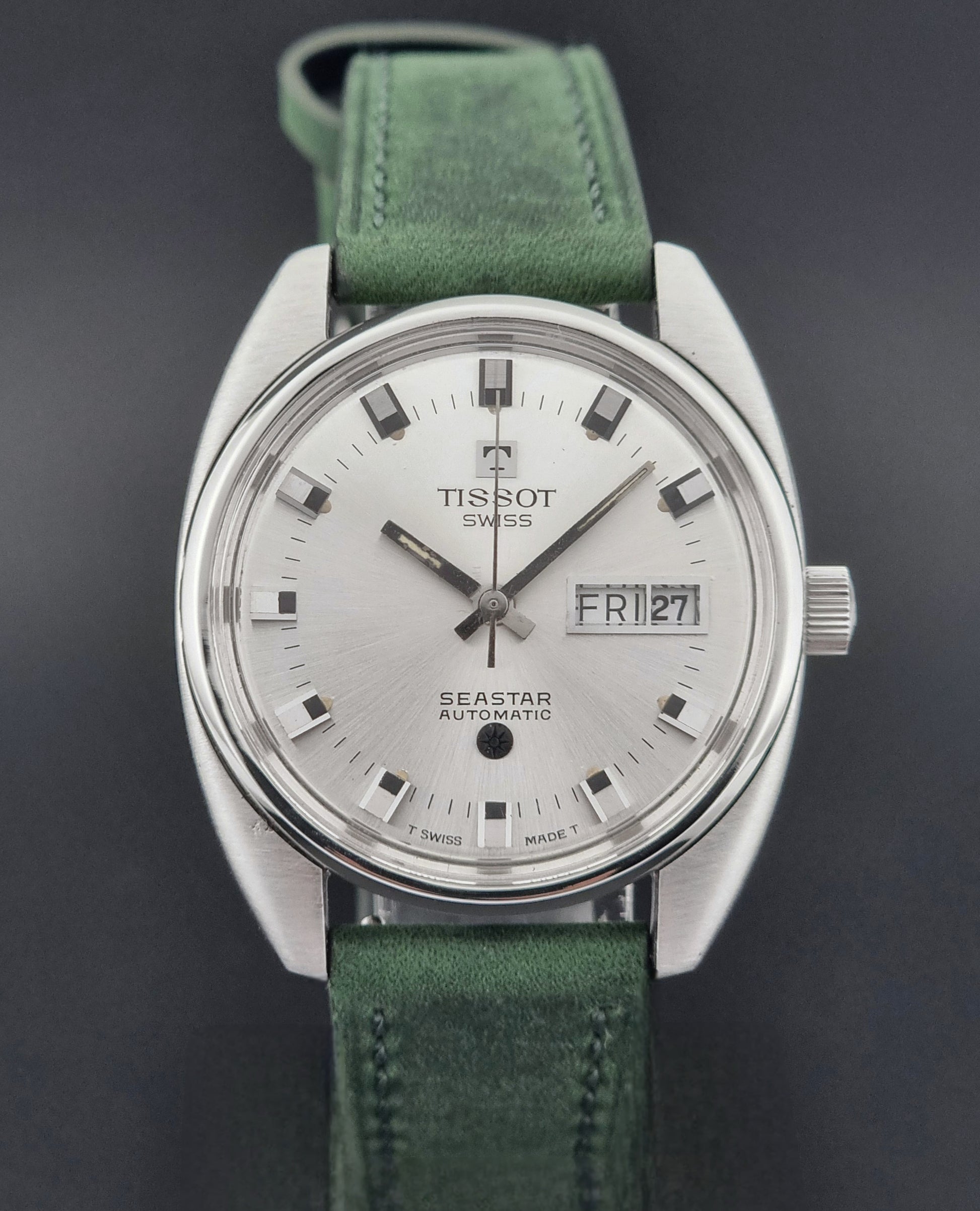 Tissot Seastar 46660 watch with green strap on a dark background