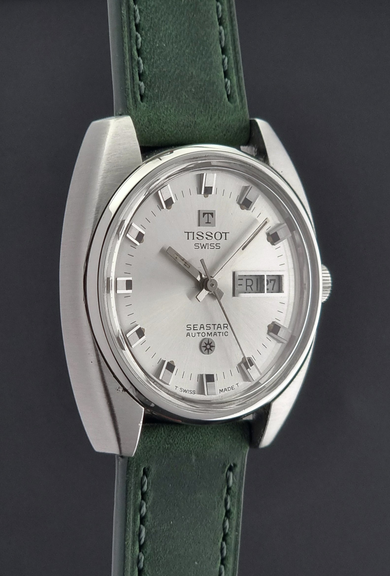 Tissot Seastar 46660 watch with green strap on a dark background