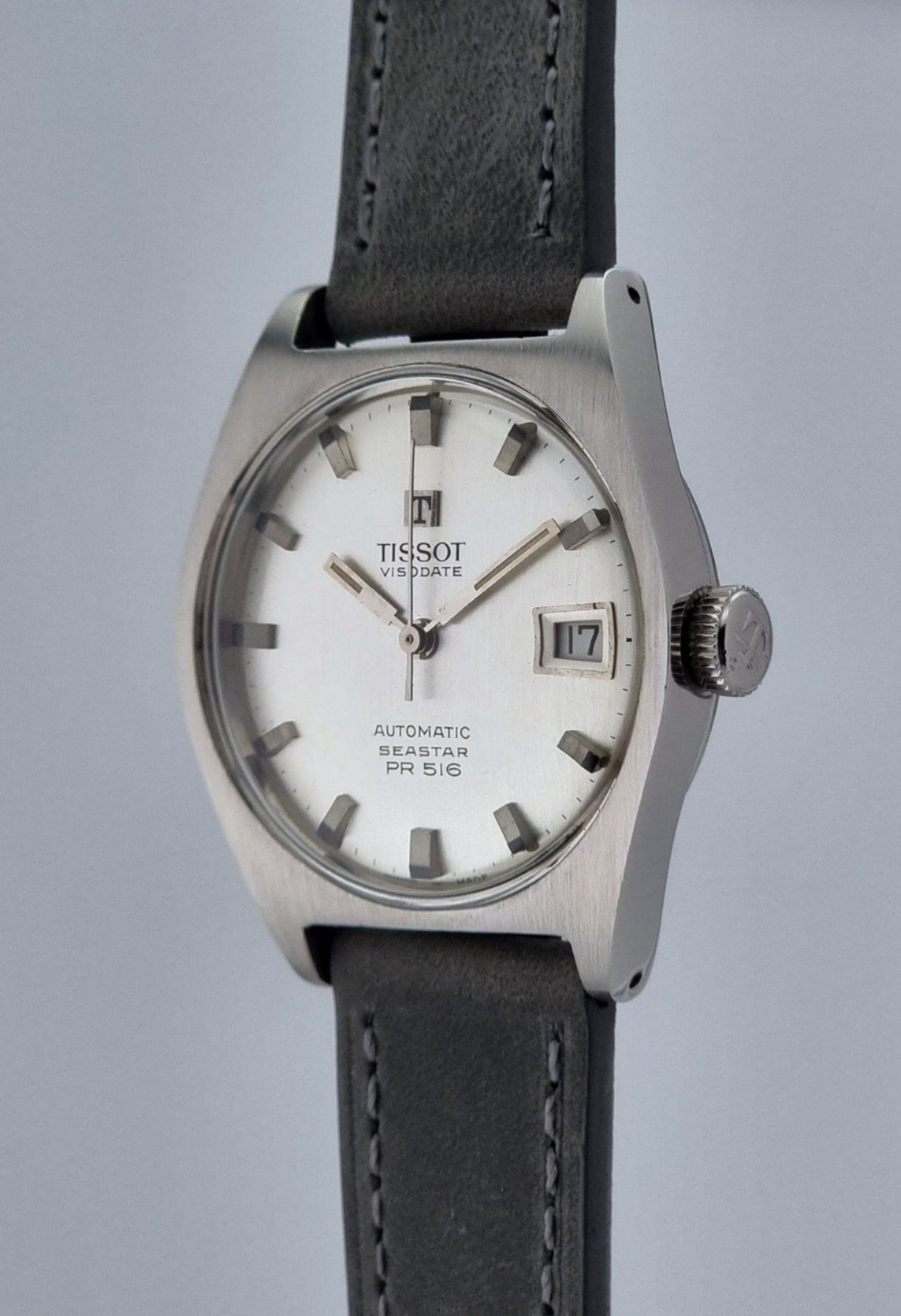 Vintage Tissot Seastar Visodate 43516 wristwatch with grey leather strap on a light background side profile view