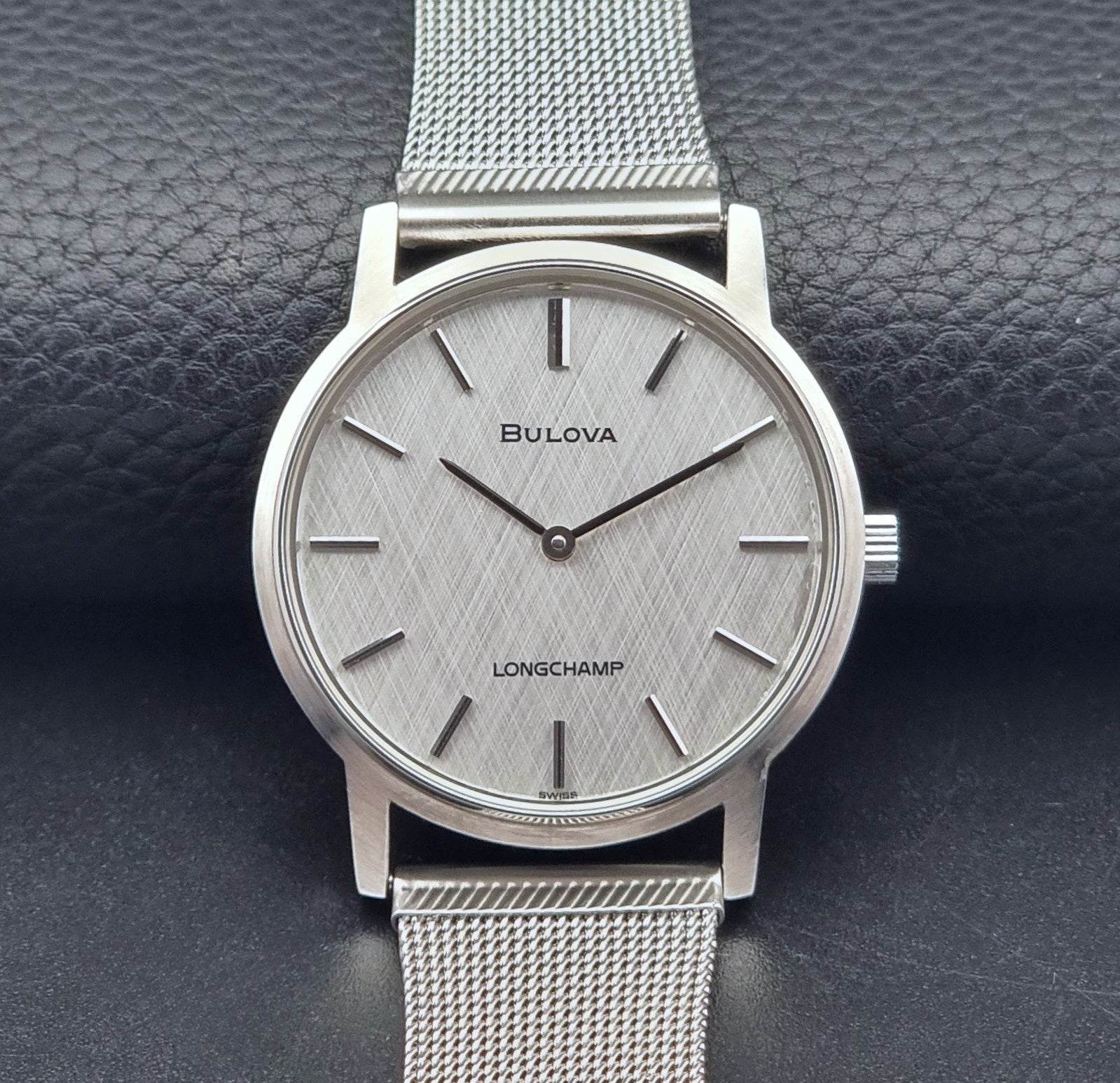 Vintage Bulova 9881 wristwatch Longchamps co-signed dial with a mesh band on a dark gray background front view