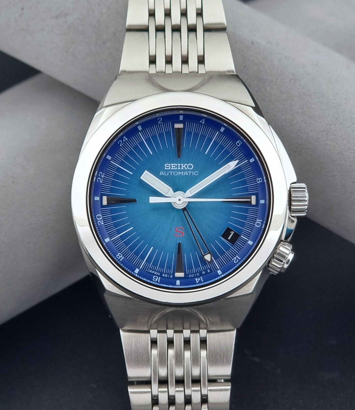 Seiko watch Mechasus SCFF009 GMT 4S12-0010 with a blue face on a dark gray background front view