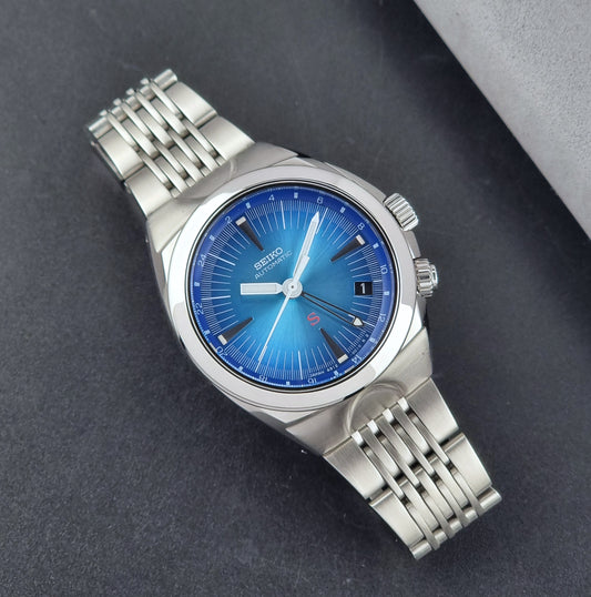 Seiko watch Mechasus SCFF009 GMT 4S12-0010 with a blue face on a dark gray background dial