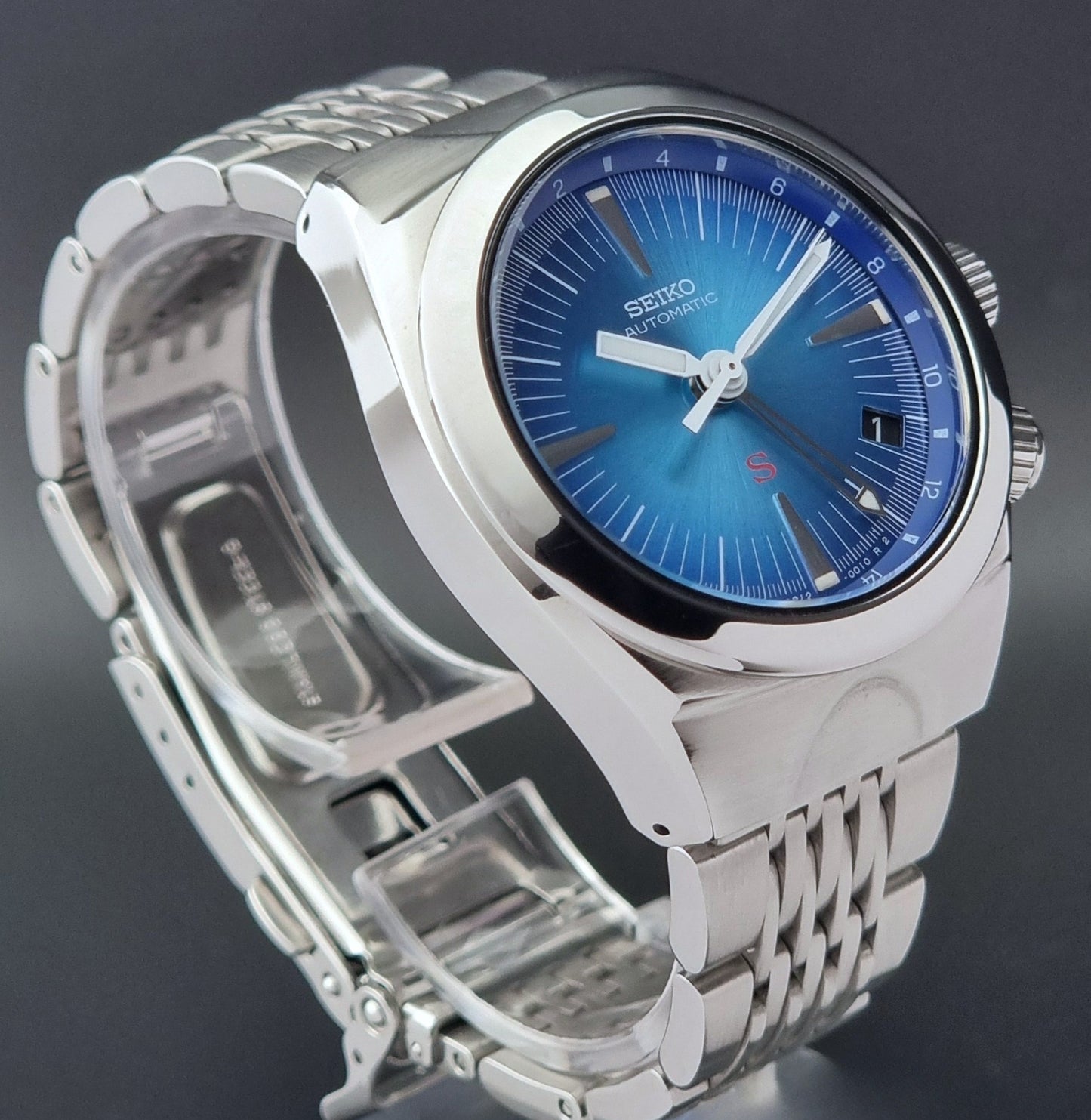 Seiko watch Mechasus SCFF009 GMT 4S12-0010 with a blue face on a dark gray background side profile view