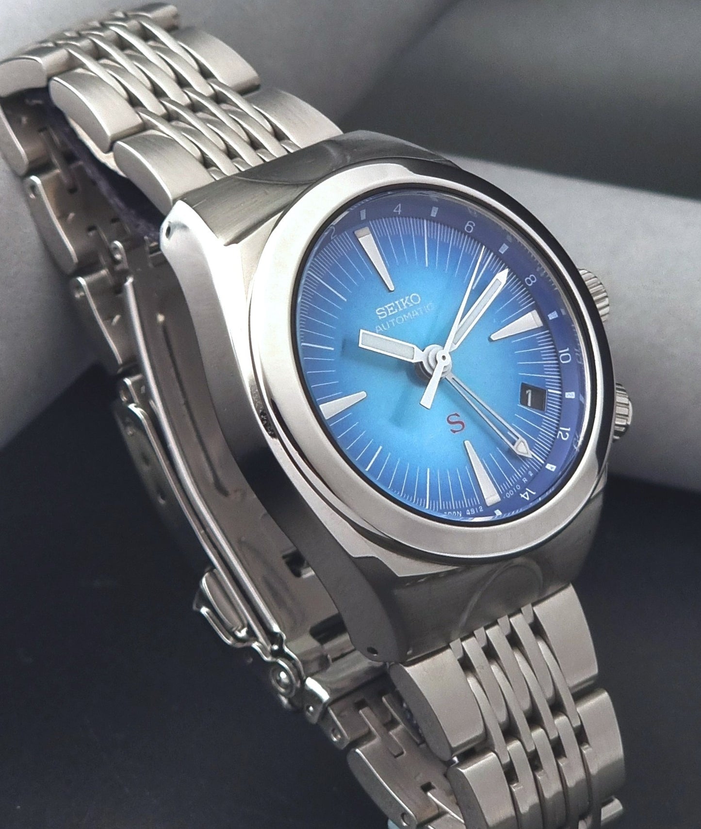 Seiko watch Mechasus SCFF009 GMT 4S12-0010 with a blue face on a dark gray background side view