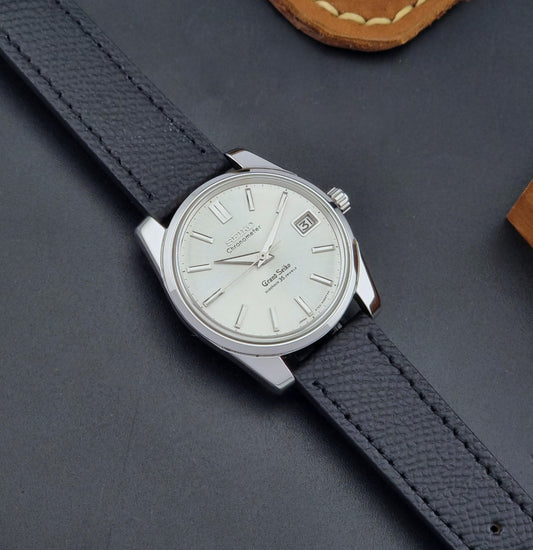 Vintage Grand Seiko Wristwatch 43999 leather strap on a gray background dial