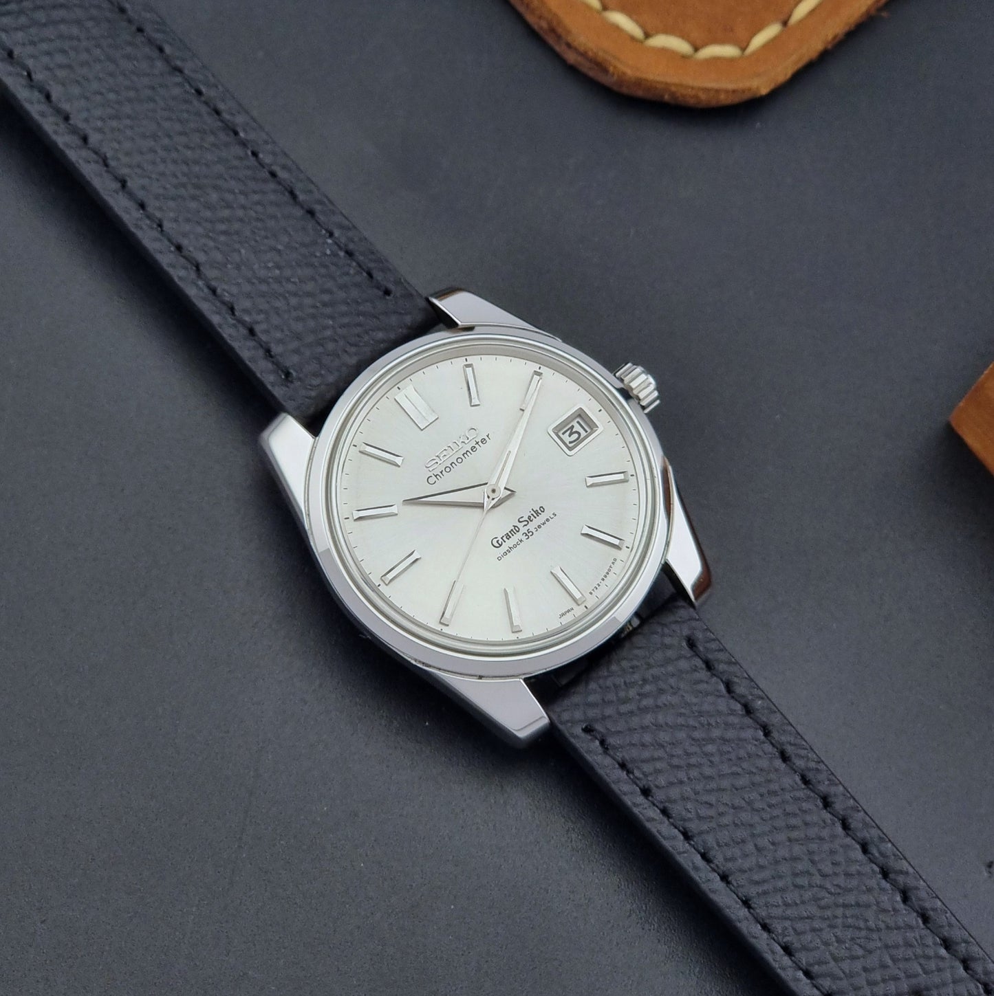 Vintage Grand Seiko Wristwatch 43999 leather strap on a gray background lose up dial view