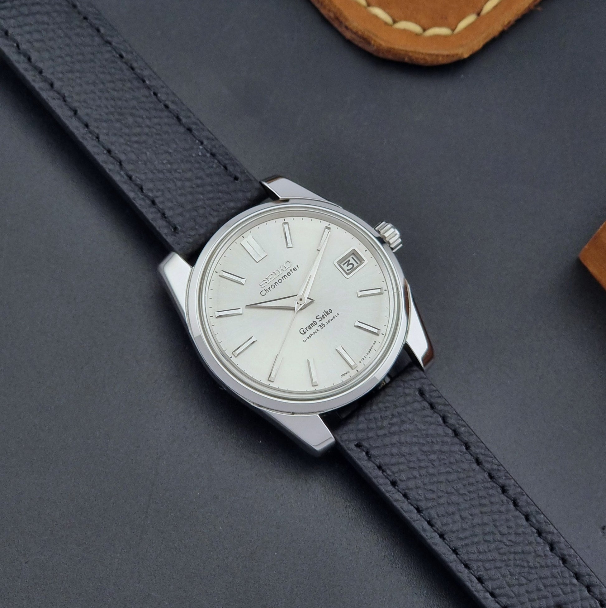 Vintage Grand Seiko Wristwatch 43999 leather strap on a gray background lose up dial view