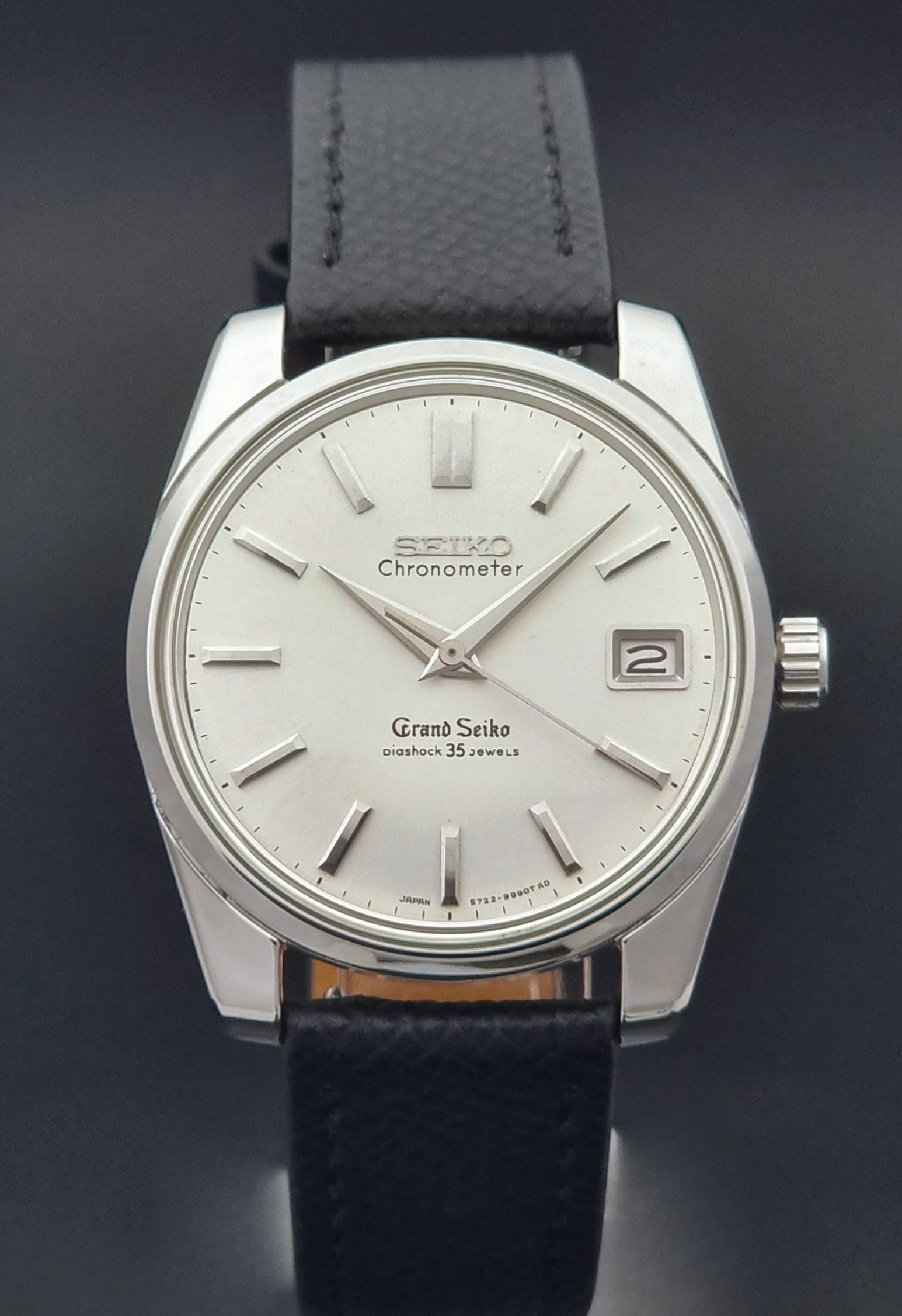 Vintage Grand Seiko Wristwatch 43999 leather strap on a gray background close dial view