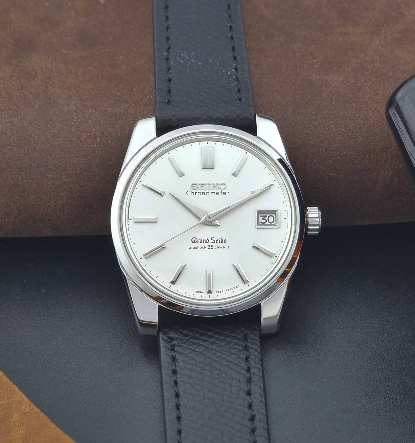Vintage Grand Seiko Wristwatch 43999 leather strap on a gray background dial view