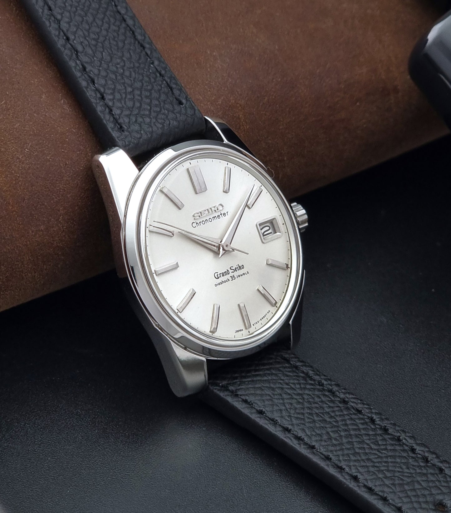 Vintage Grand Seiko Wristwatch 43999 leather strap on a gray background side view