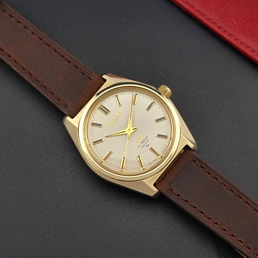 Vintage Grand Seiko 4520-8000 gold watch with brown leather strap on a dark background