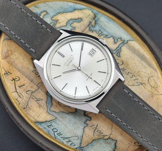 Vintage  Grand Seiko Watch with gray strap on an old map background
