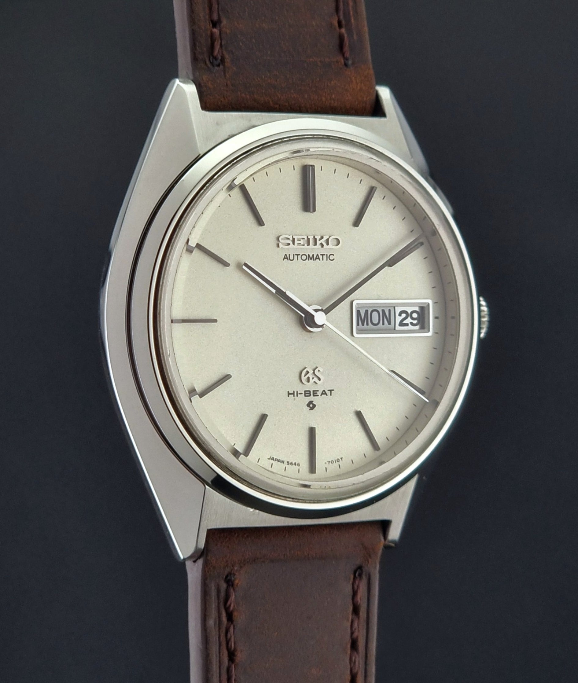 Vintage Grand Seiko Watch with brown leather strap on a dark background