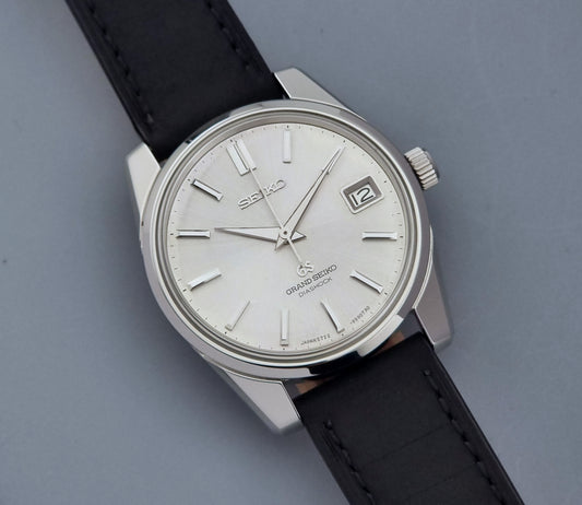 Vintage Grand Seiko Wristwatch 5722-9991 with black leather strap on a gray background