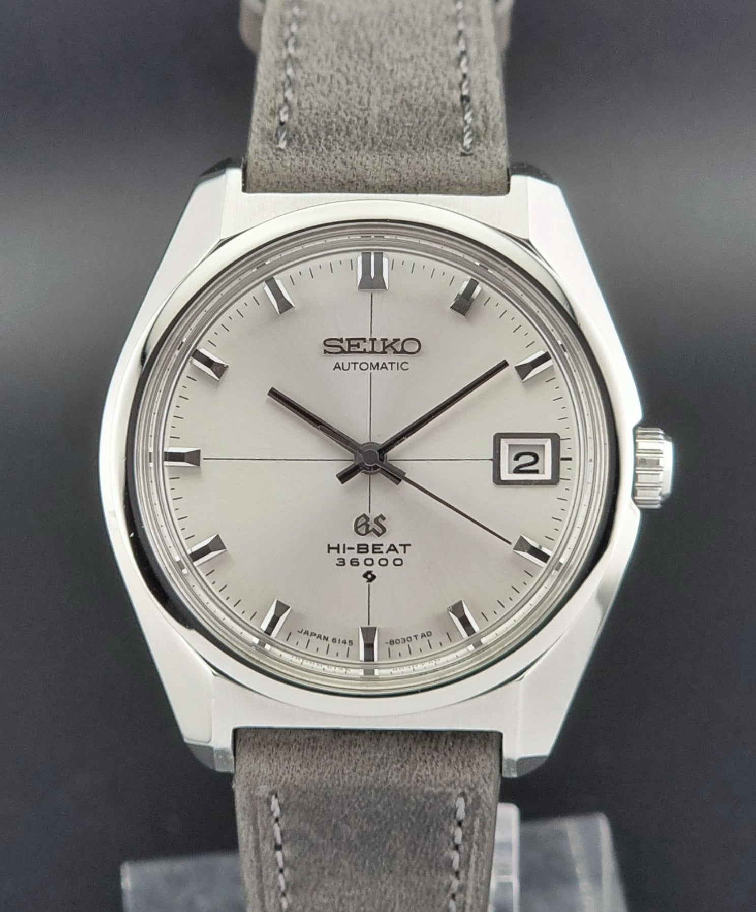 Vintage Grand Seiko watch with gray strap on a dark background