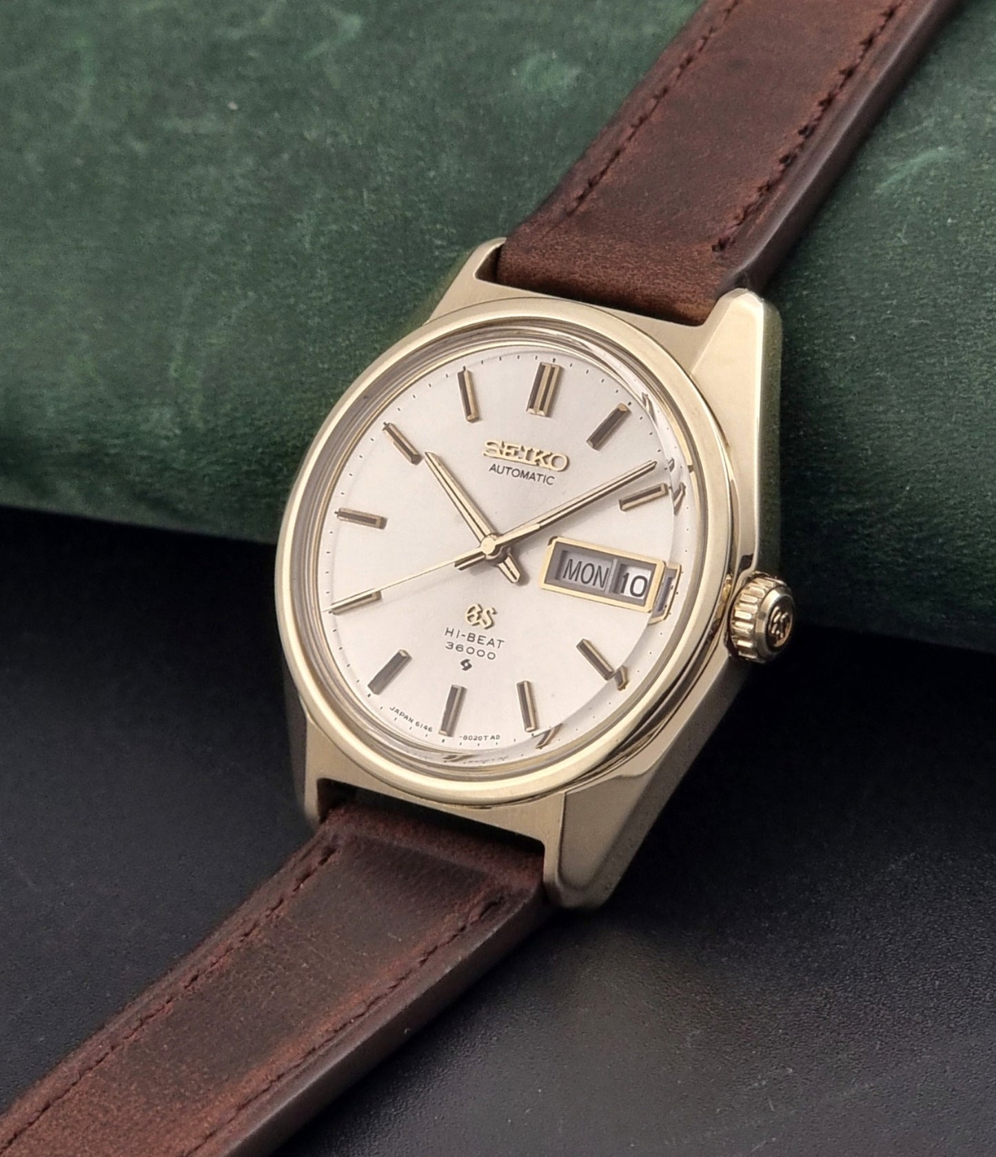 Vintage Grand Seiko watch 6146-8000 in gold with a brown leather strap crown view