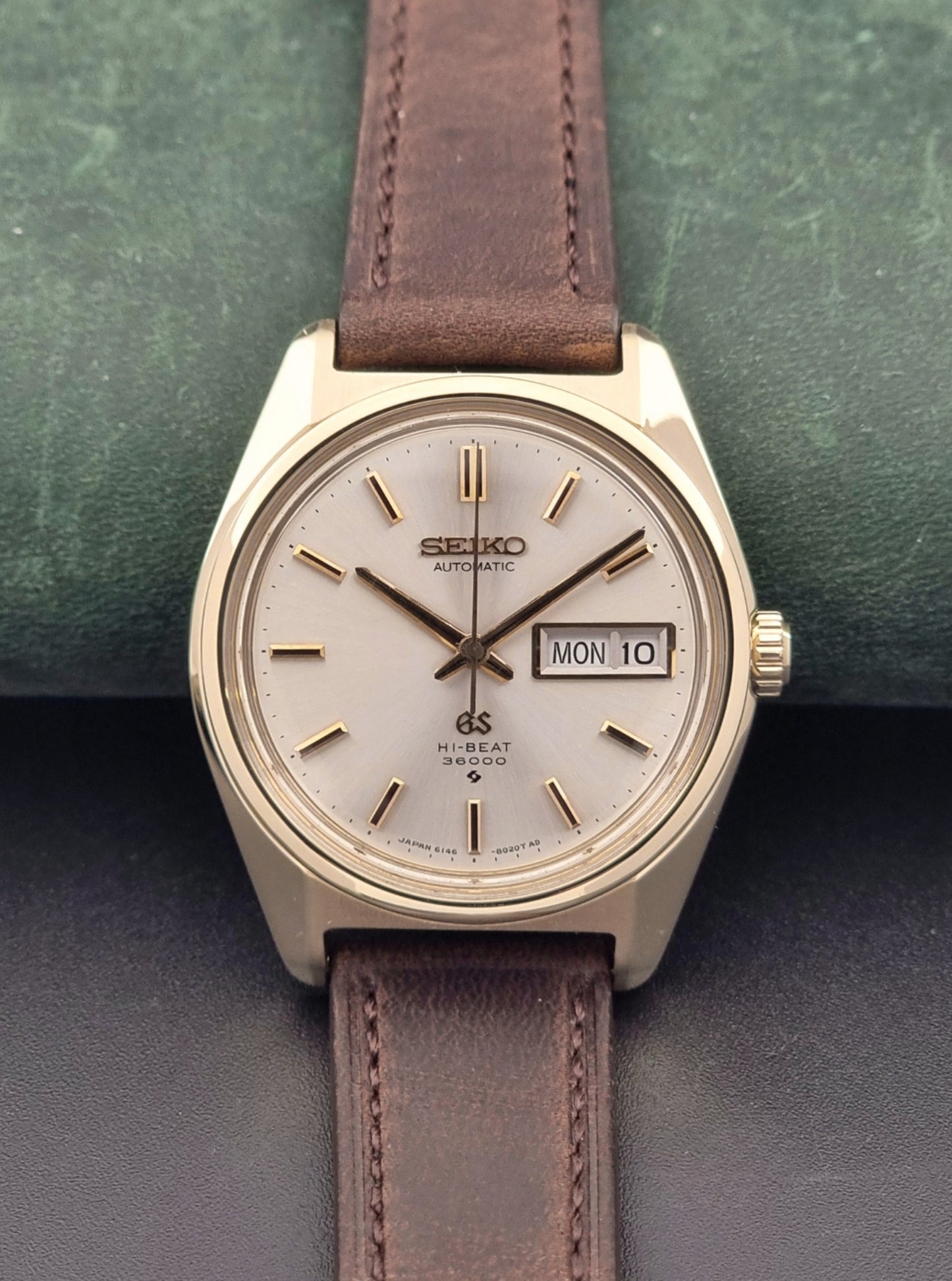 Vintage Grand Seiko watch 6146-8000 in gold with a brown leather strap front
