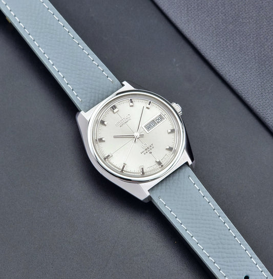 Vintage  Grand Seiko watch 6146-8000  with grey strap on a dark gray background dial