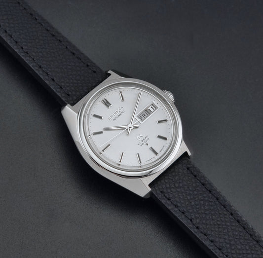 Vintage Grand Seiko 6146-8000 Wristwatch with a black leather strap on a dark background dial