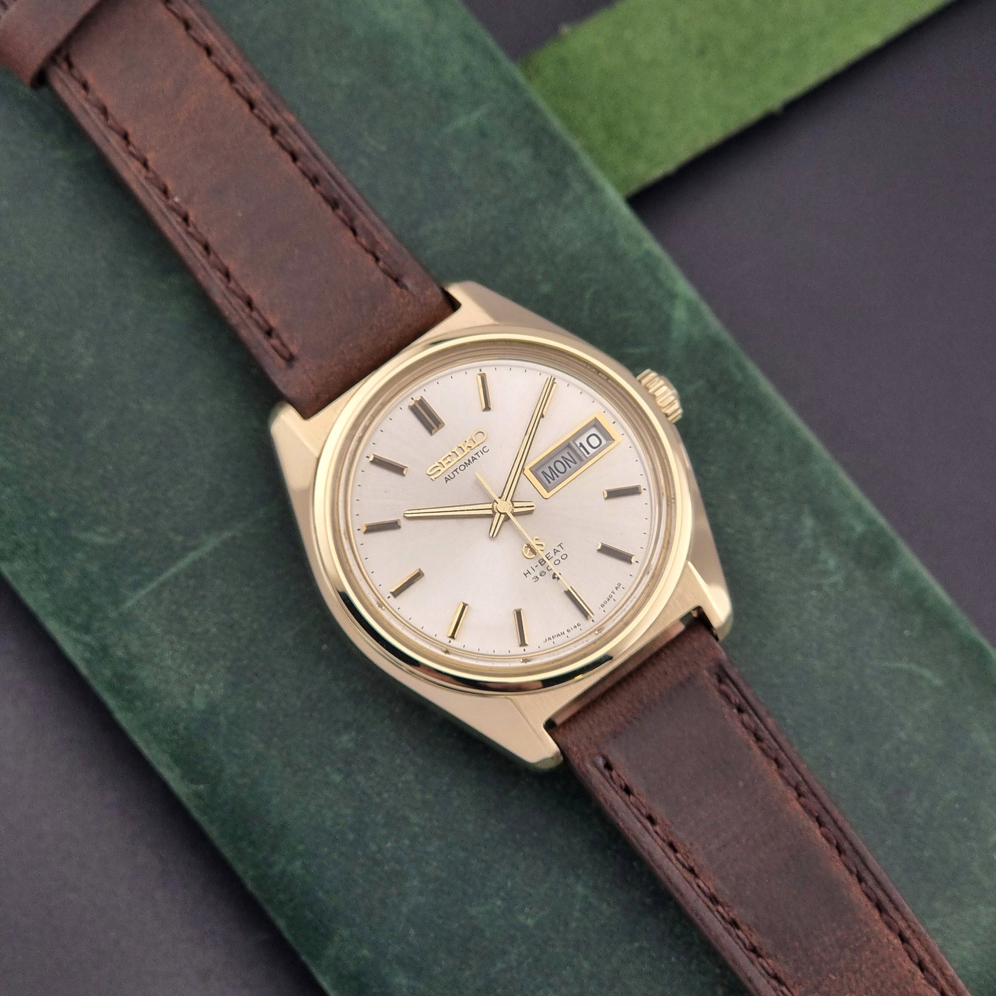 Vintage Grand Seiko watch 6146-8000 in gold with a brown leather strap