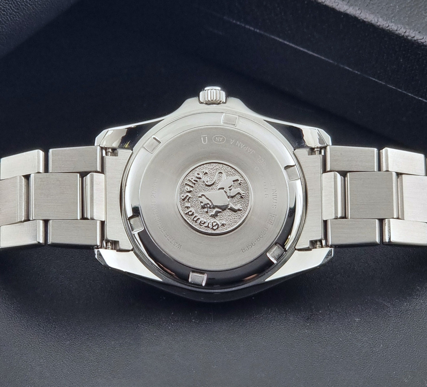 Grand Seiko SBGF021 quartz 8J56-8020 watch with a dark face on a dark background case back view