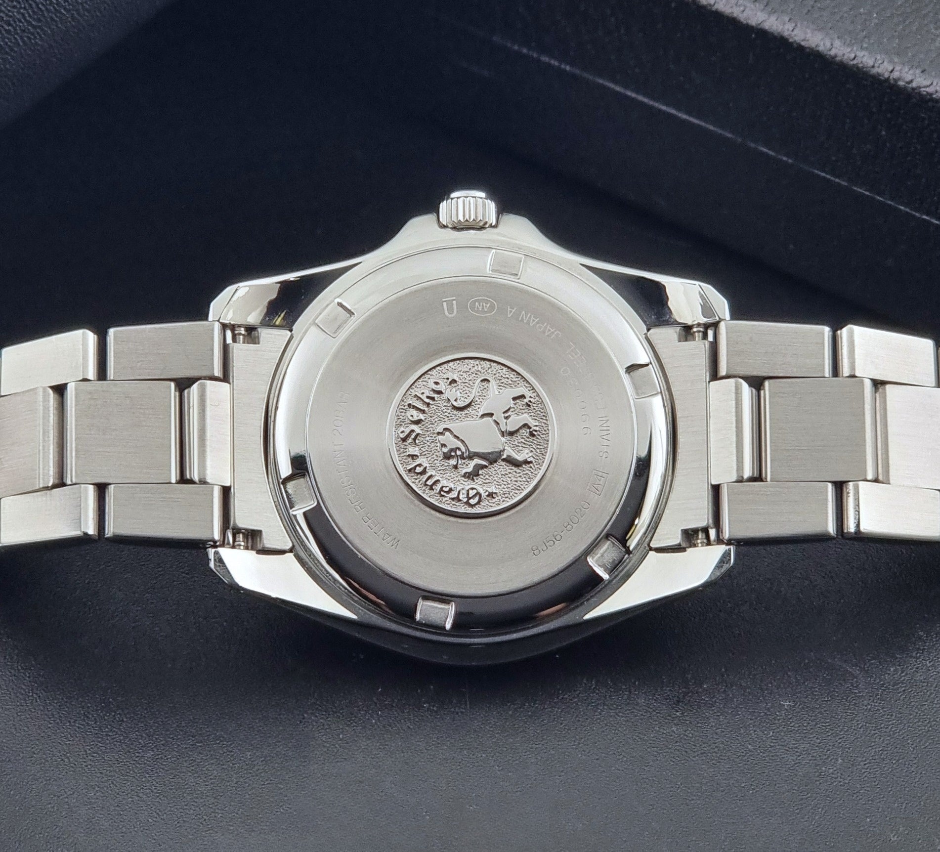 Grand Seiko SBGF021 quartz 8J56-8020 watch with a dark face on a dark background case back view