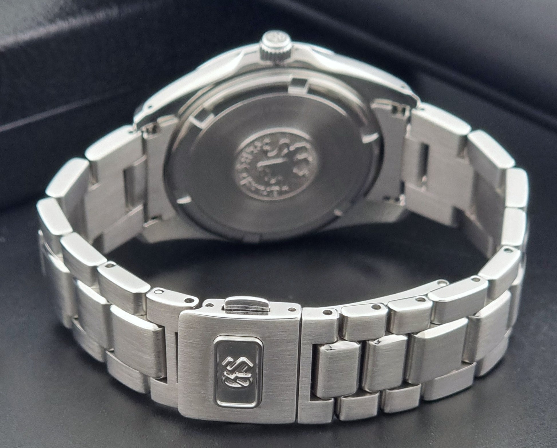 Grand Seiko SBGF021 quartz 8J56-8020 watch with a dark face on a dark background clasp view