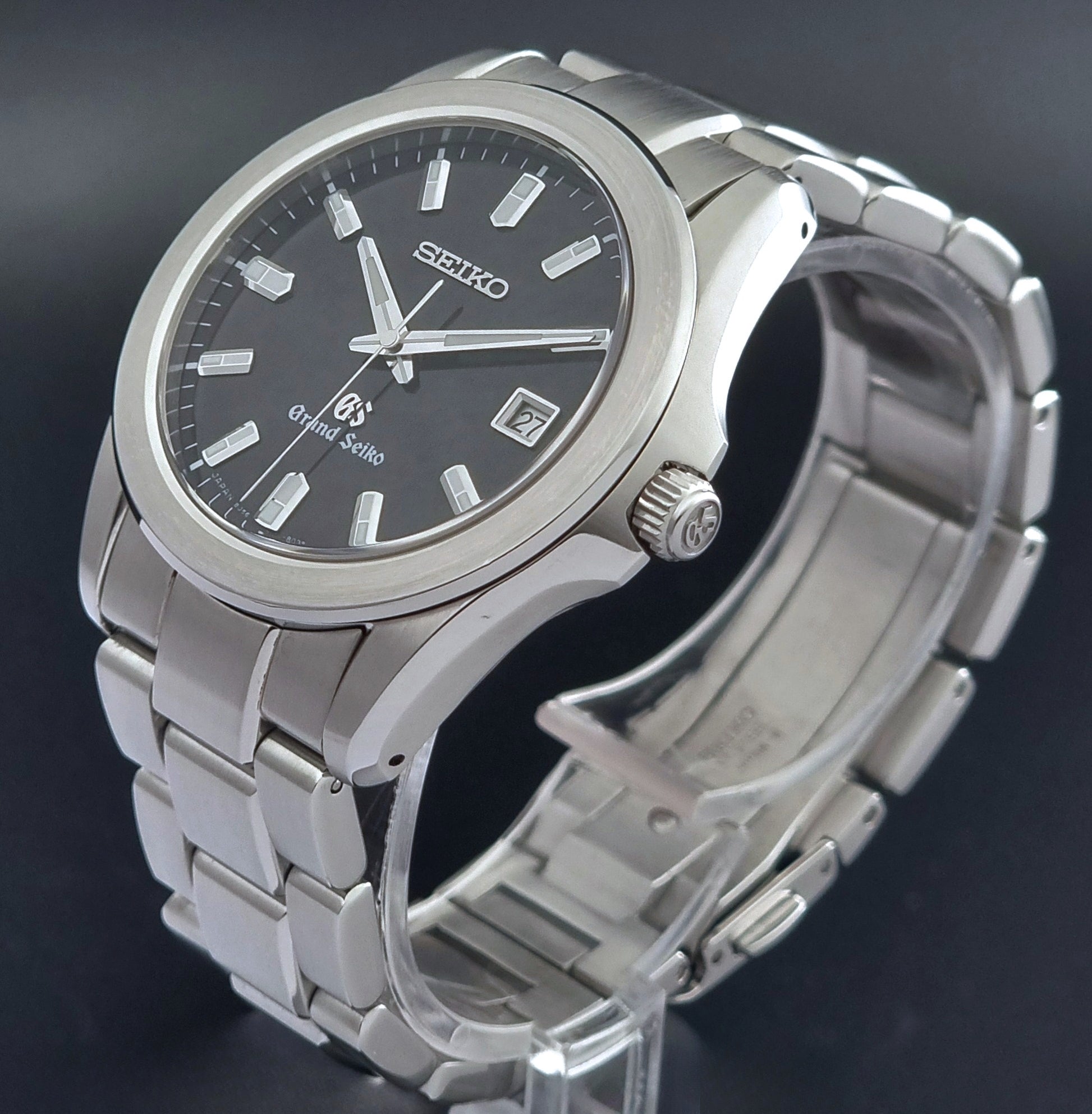 Grand Seiko quartz watch 8J56-8020 with a dark face on a dark background crown profile view