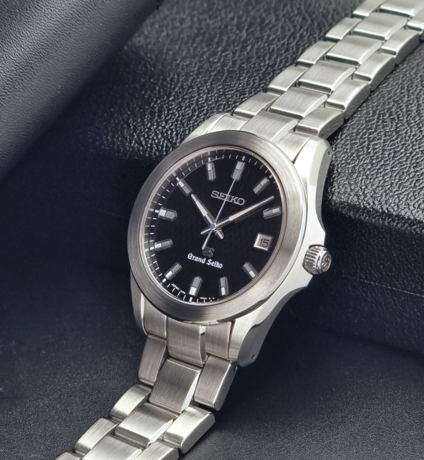 Grand Seiko SBGF021 quartz 8J56-8020 watch with a dark face on a dark background crown view