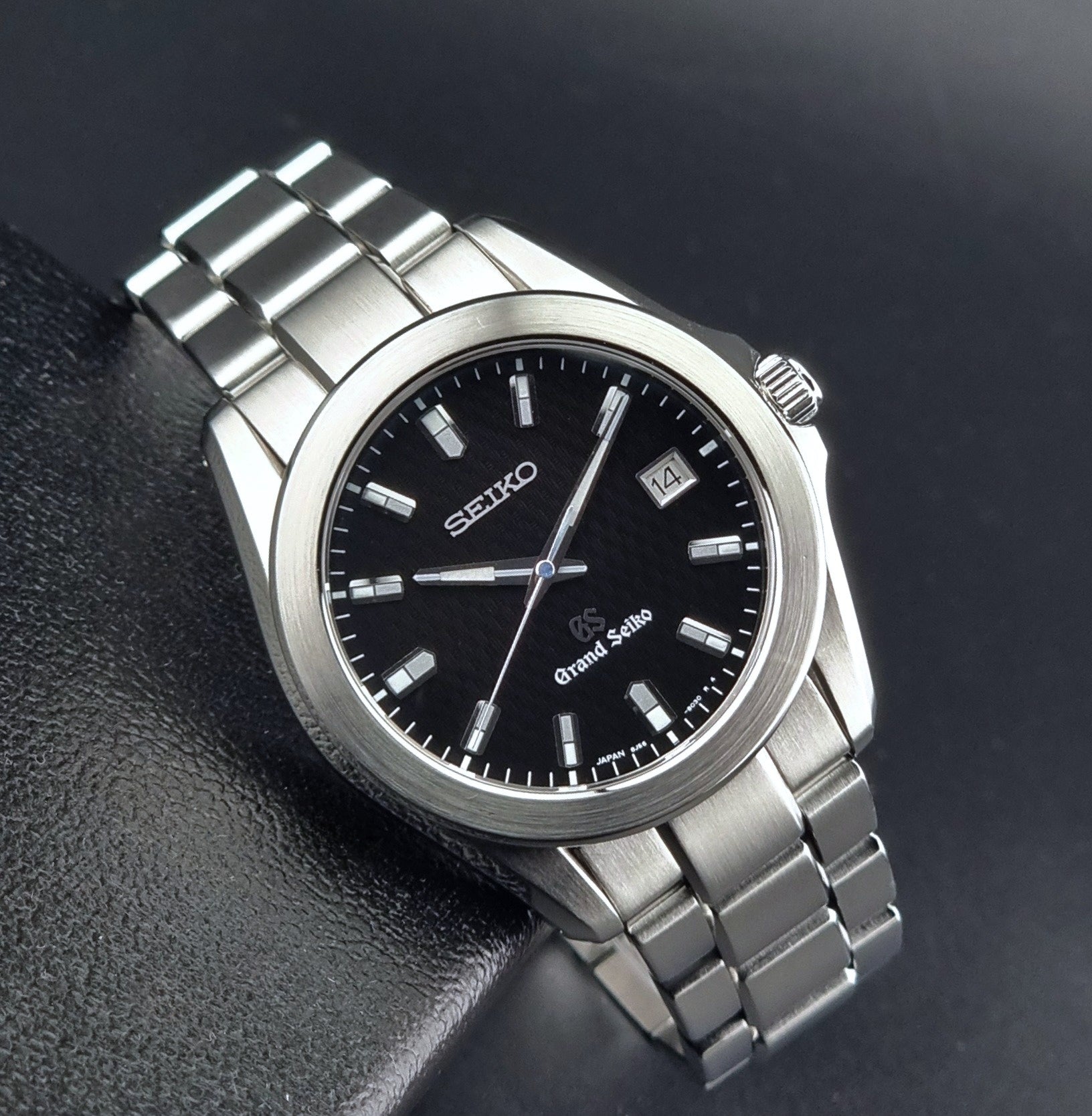 Grand Seiko SBGF021 quartz 8J56-8020 watch with a dark face on a dark background dial view