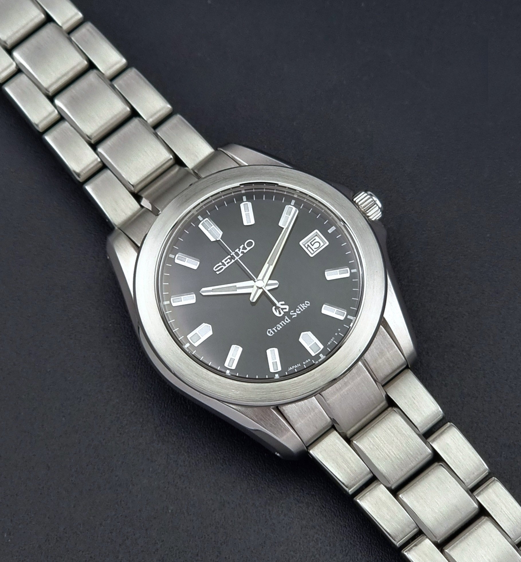 Grand Seiko SBGF021 quartz 8J56-8020 watch with a dark face on a dark background front view