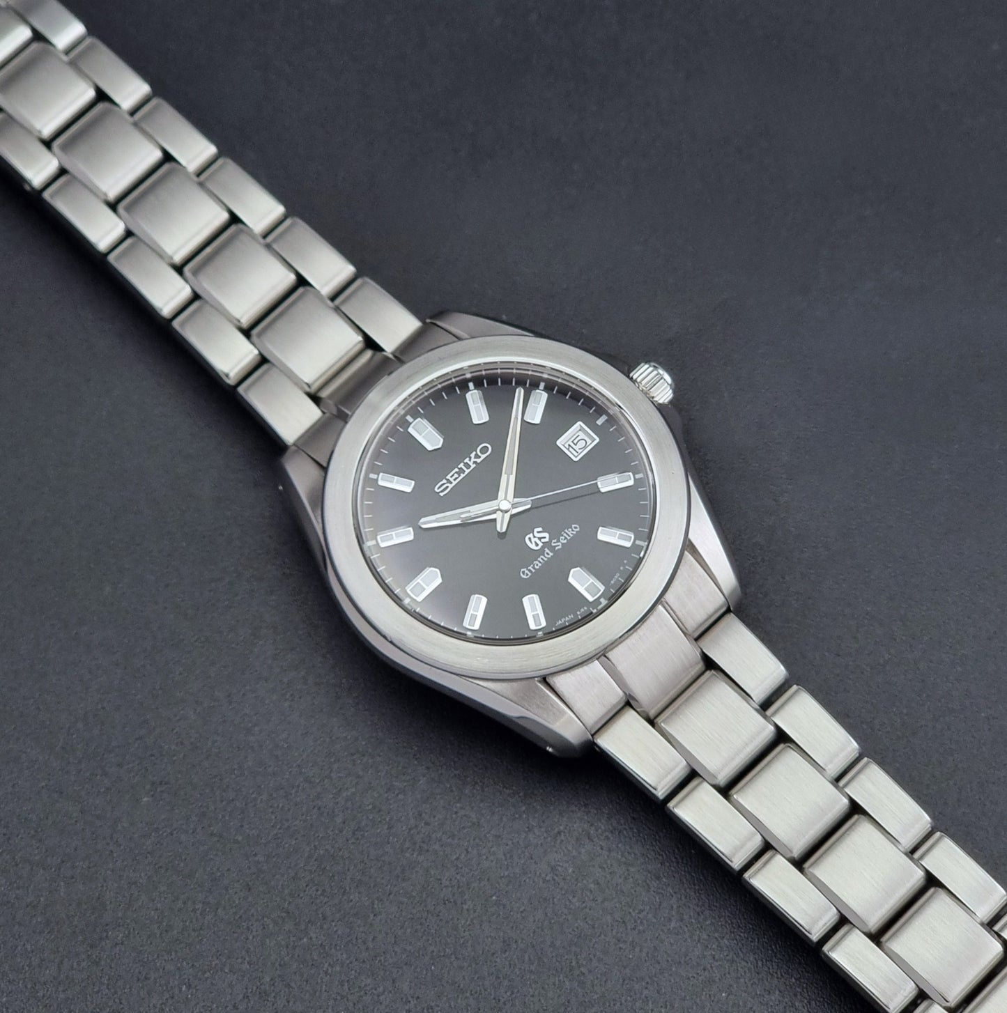 Grand Seiko SBGF021 quartz 8J56-8020 watch with a dark face on a dark background dial