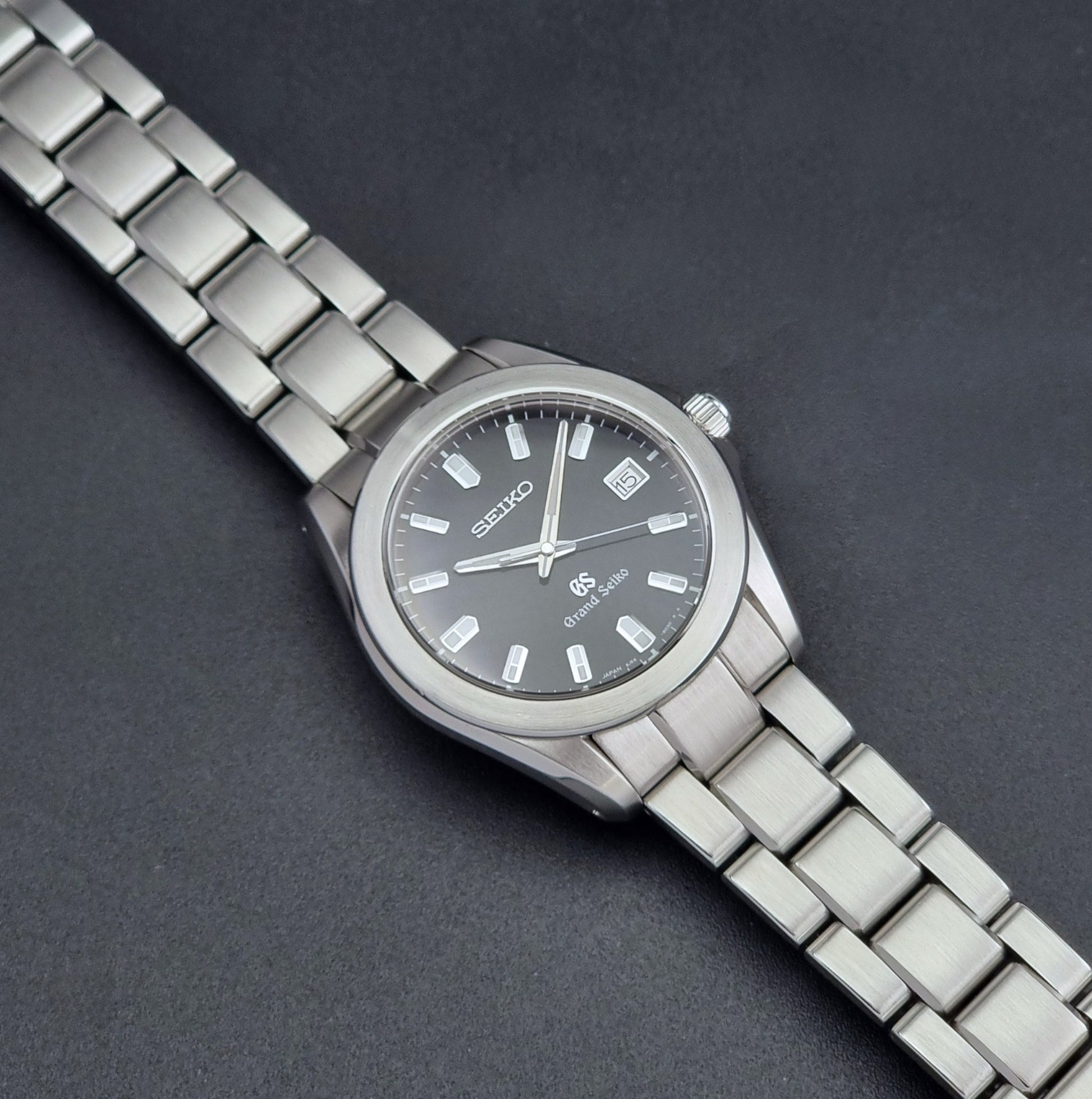 Grand Seiko SBGF021 quartz 8J56-8020 watch with a dark face on a dark background dial