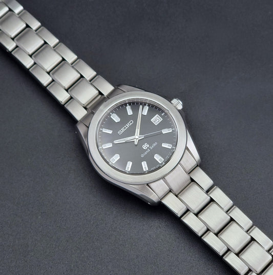 Grand Seiko SBGF021 quartz 8J56-8020 watch with a dark face on a dark background dial