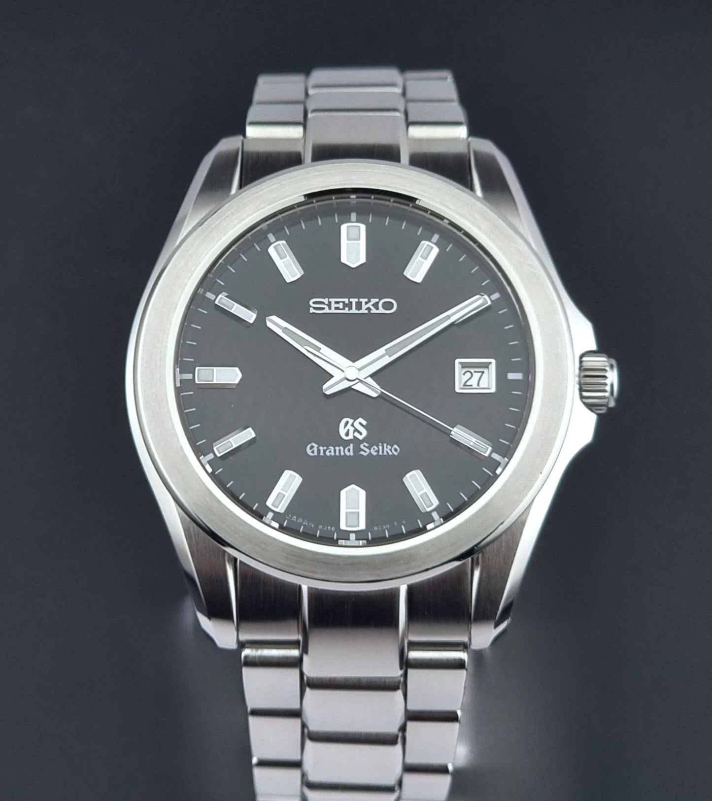 Grand Seiko quartz watch 8J56-8020 with a dark face on a dark background close dial view