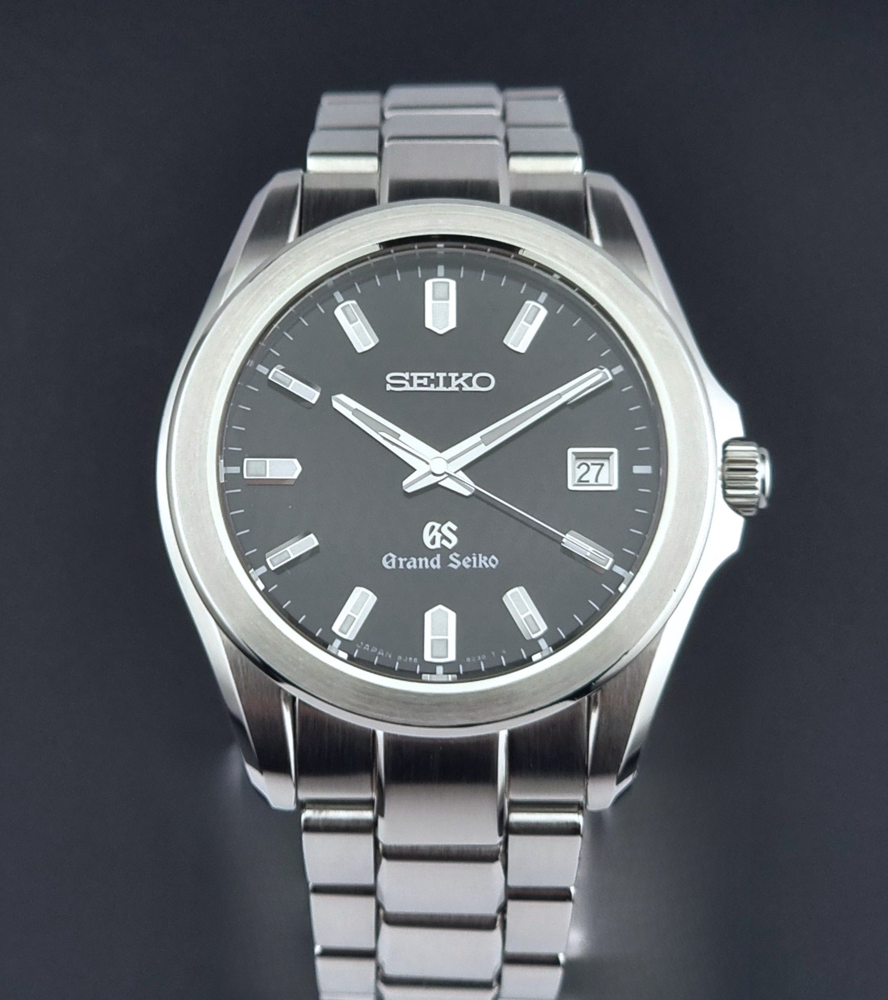 Grand Seiko quartz watch 8J56-8020 with a dark face on a dark background close dial view